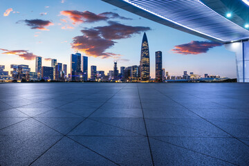 City square and pedestrian bridge with modern buildings scenery at night in Shenzhen, China.