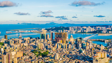 Aerial view of the Macau city skyline with modern buildings at sunset by the sea. Famous travel destination.