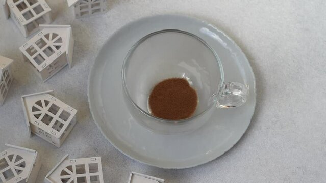 Pour chicory or instant coffee into a transparent cup. Preparing a hot drink.
