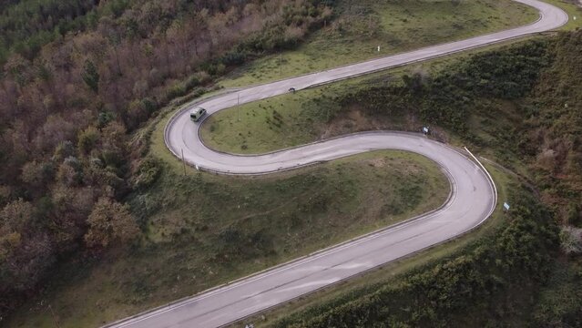 a camper van on a mountain road with many curves, ideal scenery
