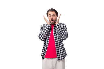 young surprised bearded brunette man in a shirt on a white background with copy space