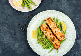 Salmon roasted in an oven with vegetables.