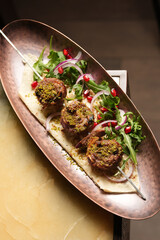 Shashlik or shish kebab with herbs, onion and pomegranate