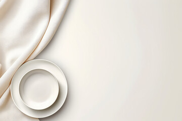 Empty plate and napkin on white silk background, top view with copy space