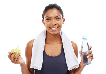 Portrait, apple and water for fitness with a woman in studio isolated on a white background for health. Exercise, smile and towel with a confident young athlete at the gym for training or nutrition