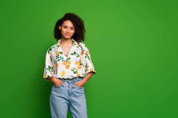 Photo of cute adorable lady wear print shirt standing hands pockets empty space isolated green color background