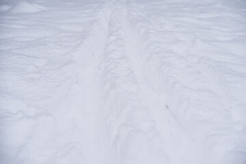 Winter road with snow close up background