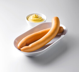Frankfurter sausage with mustard isolated on white background.