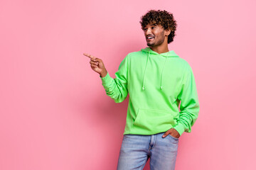Photo of young student man wear green hoodie pointing finger empty space cheap restaurant near hostel isolated on pink color background - obrazy, fototapety, plakaty