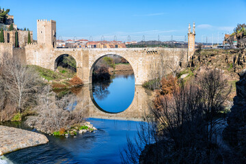 Medieval Alcantara bridge in Toledo and river Tajo. Spain. Europe.