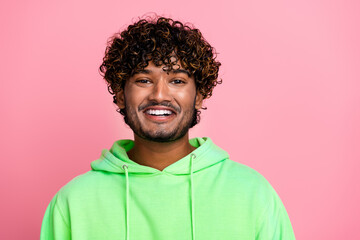Portrait of smiling boyfriend handsome arabian guy wearing trendy green sweatshirt with like expression isolated on pink color background