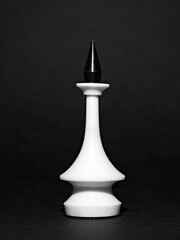 White chess piece King on a black background. Black and white photo.