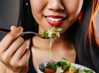 Latin beauty young model, brunette woman, eating salad. Healthy diet concept. Closeup portrait.
