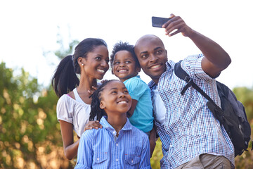 Happy black family, selfie and photo in nature for hiking, bonding or outdoor photography together. African mother, children and father smile taking picture or photograph for adventure in forest