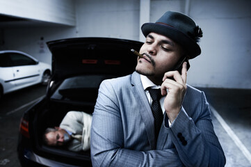 Phone call, car and criminal with hostage in trunk for negotiation, kidnapping danger and crime....