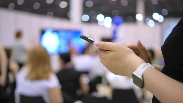 Hands of women with gadgets at business conference