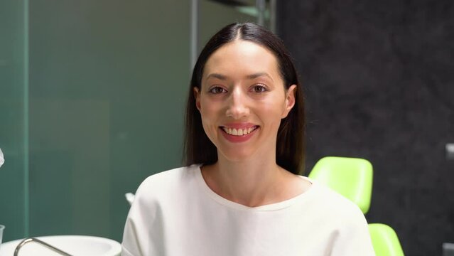 Happy caucasian woman smiling to camera, showing white smile of after teeth alignment procedure