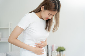 stomach ache. Asian women have abdominal pain, indigestion, gastritis, menstrual cramps,...