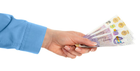 Female hand holding British pounds currency isolated on white background