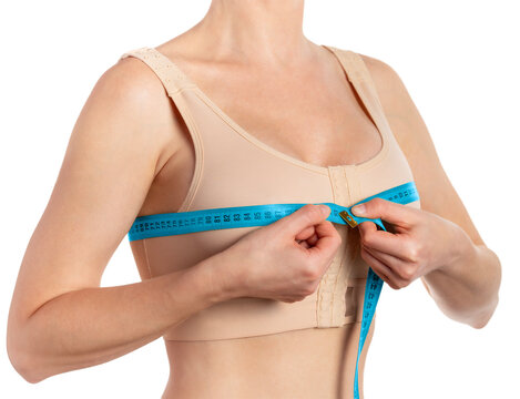 Woman taking measurements after breast augmentation isolated on white background 