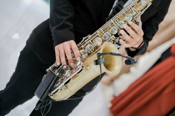 Saxophonist playing music. close up saxophone