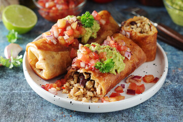A typical dish of Mexican cuisine - Chimichanga, made of tortilla with different ingredients