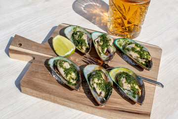 stuffed mussels on a wooden plate