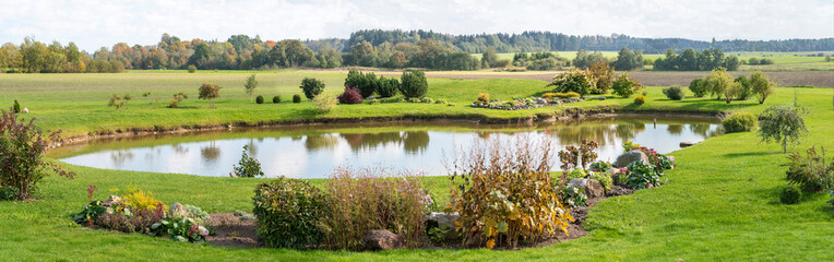 Beautiful landscape with pond, meadow and trees