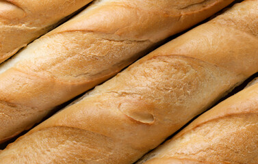 Baguettes of bread closeup, background. Top view