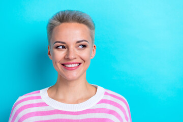 Portrait of good mood pretty girl with dyed hairdo wear stylish pullover look at sale empty space isolated on turquoise color background