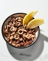 Sauteed Calamari. Baby Calamari cooked with oregano, thyme and garlic (Italian Style). Served with lemon and red pepper flakes. Spicy
