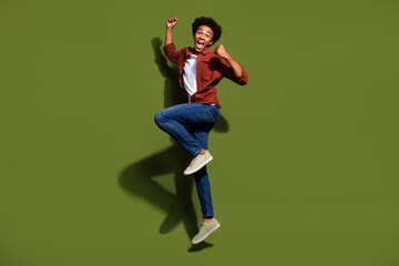 Full body photo of attractive young man jump celebrate winning hooray wear trendy brown clothes...