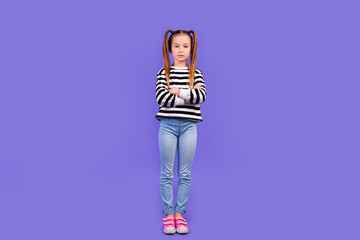 Full length photo of positive confident little child dressed striped pullover arms crossed empty...