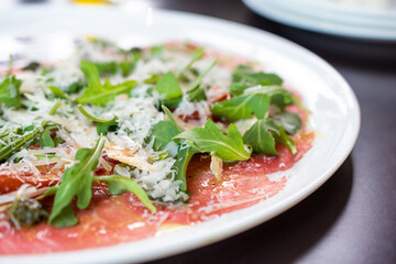 Steak tartare with arugula and Parmesan cheese