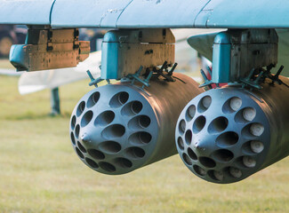 army military rocket launcher on the wing of an airplane