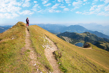 young woman at hiking trail Rofanspitze, looking to lake  Zireiner See and Inntal valley