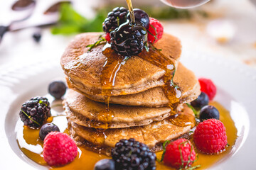Pancakes with fruit and syrup drizzle