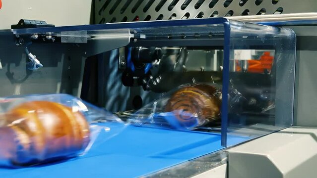 Poppy Seed Buns Are Wrapped In Transparent Packaging Film On The Packaging Line