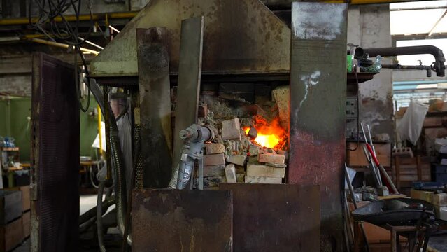 High temperature flames coming out of Murano glass furnace, Italy