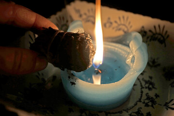 Burning White sauge on Blue candle 