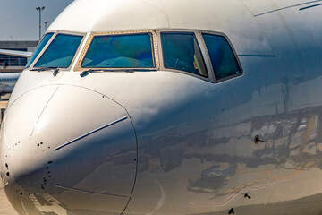 Photograph of the cockpit of an airline wide-body commercial aircraft parked at John F. Kennedy International Airport, where it is being loaded for a new journey on a new course.