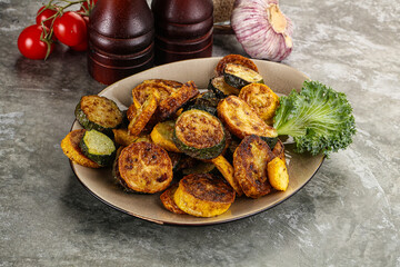 Roasted young zucchini in the plate