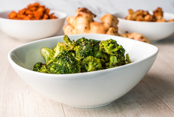 Roasted broccoli in a white bowl