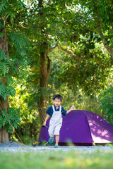 Fototapeta premium Happy kindergarten 5 year asian boy enjoying outdoor camping in rain forest camp site