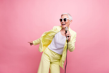 Photo of cool artist concert business lady in yellow suit singing into microphone point finger...