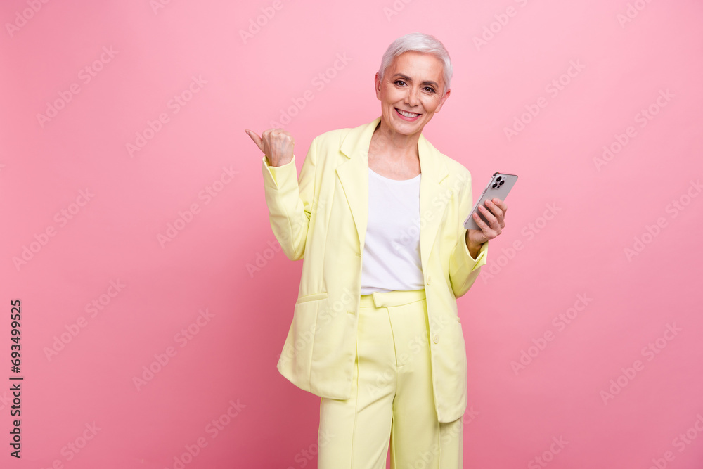 Sticker Photo of smiling businesswoman point finger youtube channel free video lessons about finance investments isolated on pink color background