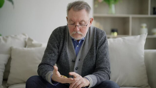 Hands of man holding stones to calm. Pensioner shifts anti-stress stones on hand palm. Soothing practices to stabilize nervous system, improve well-being. Method of solution psychological problems.