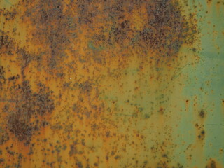 The zinc is painted green and in old, rusty condition. Brown rust eats away at the steel plate until it decays. Some parts of the steel sheets outside the building may be exposed to water, sunlight 
