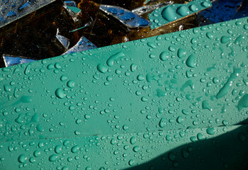 Sharp mirror waste with waterdrops waiting the transport back to the glass factory to recycle.