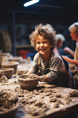 A child first experience with clay at a pottery wheel. - obrazy, fototapety, plakaty
